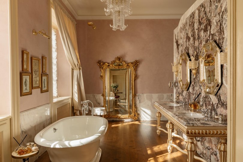 A free-standing bath sits on polished floorboards in the bathroom of the Grand Junior Suite in the Villa.
