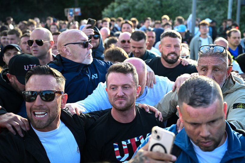 British far-right activist Tommy Robinson, real name Stephen Yaxley-Lennon, stands with demonstrators protesting over the police's handling of the arrest of Henry Nowak in June.