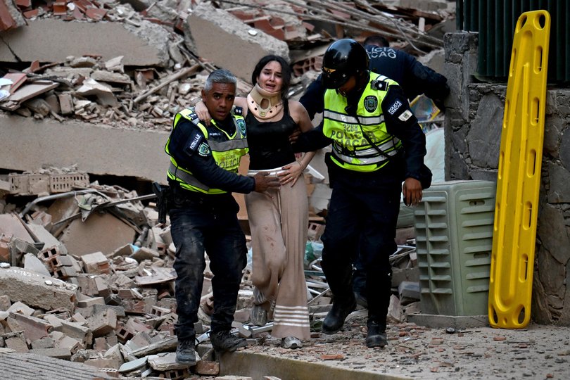 Municipal police officers evacuate an injured victim from a collapsed building following an earthquake in Caracas on June 24, 2026. A magnitude 7.1 earthquake struck Venezuela on Wednesday, the United States Geological Survey (USGS) reported, triggering panic in Caracas, according to AFP journalists. The tremor, which was followed by several aftershocks, was also felt in Colombia. (Photo by Juan BARRETO / AFP) Picture: JUAN BARRETO