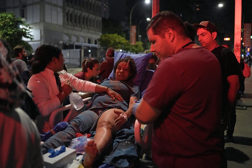 A woman is carried on a stretcher following an earthquake in Caracas.