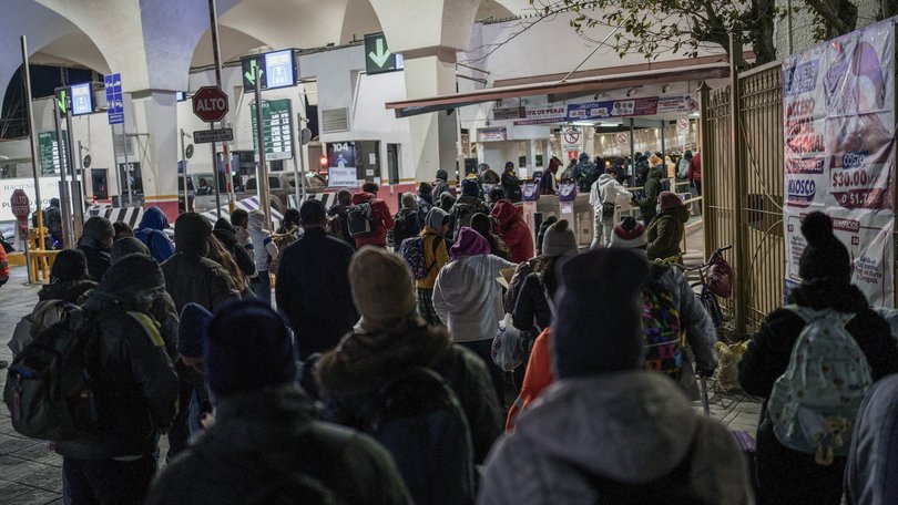 Migrants wait to enter the Paso Del Norte international bridge in Mexico.
