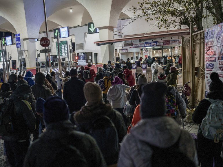 Migrants wait to enter the Paso Del Norte international bridge in Mexico.