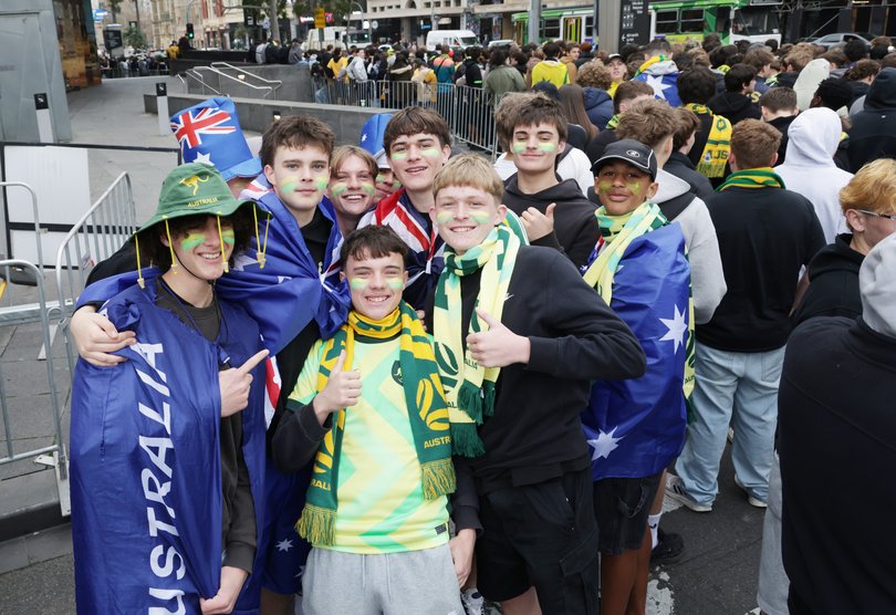 Socceroo fans pline up at Federation Square in Melbourne ahead of the World Cup game.