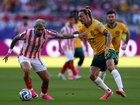 Julio Enciso #19 of Paraguay controls the ball under pressure from Jackson Irvine