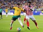 Jordan Bos #5 of Australia competes for the ball against Omar Alderete.