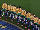 Australia players stand for the national anthem.