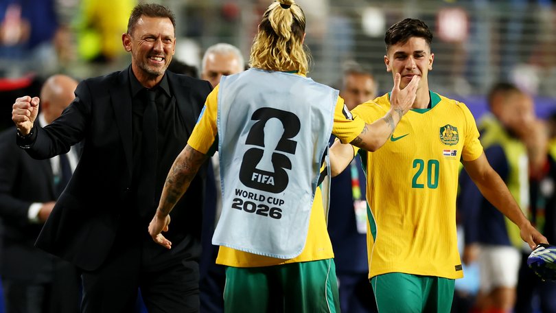 Tony Popovic, Head Coach of Australia, Cristian Volpato #20, and Jackson Irvine #22 celebrate after a 0-0 draw.