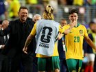Tony Popovic, Head Coach of Australia, Cristian Volpato #20, and Jackson Irvine #22 celebrate after a 0-0 draw.