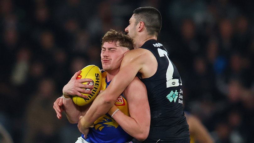 Marc Pittonet of the Blues tackles Harley Reid.