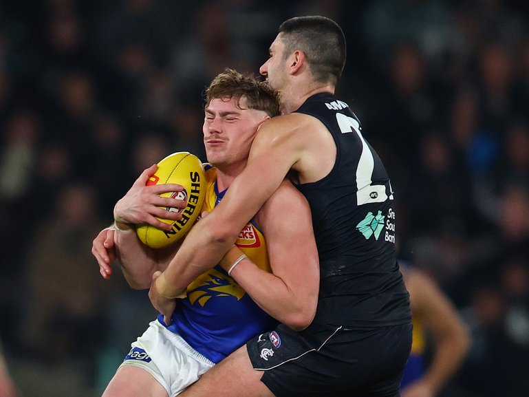 Marc Pittonet of the Blues tackles Harley Reid.