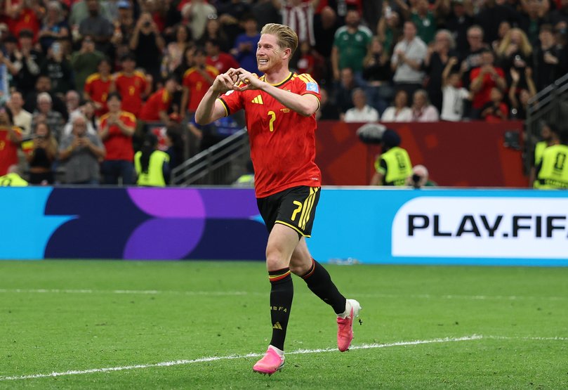 Kevin De Bruyne of Belgium celebrates with teammates after scoring his team's third goal.