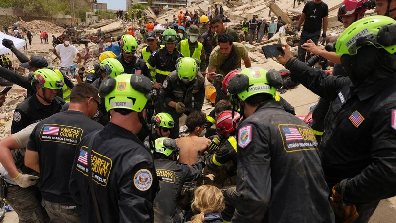 Several children have been rescued as foreign volunteers arrive to help recovery efforts.