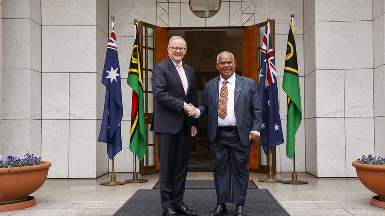 The Prime Minister of Vanuatu Jotham Napat (R) shakes hands with Prime Minister Anthony Albanese at Parliament House.