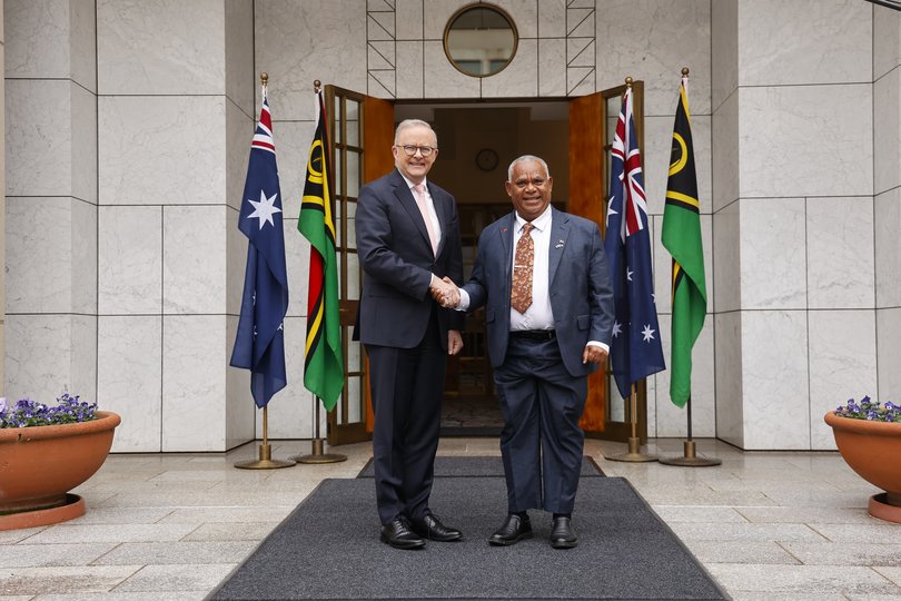 The Prime Minister of Vanuatu Jotham Napat (R) shakes hands with Prime Minister Anthony Albanese at Parliament House.
