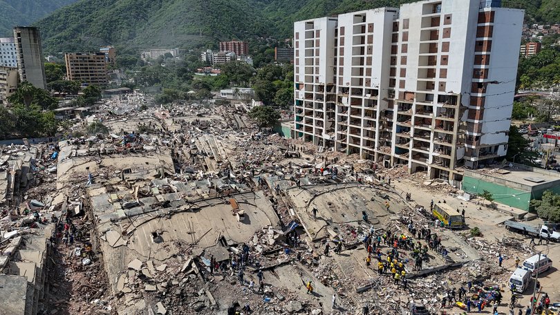 Rescue workers stand on collapsed buildings amid damaged ones along the coast in Caraballeda, La Guaira state, Venezuela, Sunday, June 28, 2026, after earthquakes. (Miguel Medina, Pool photo via AP)