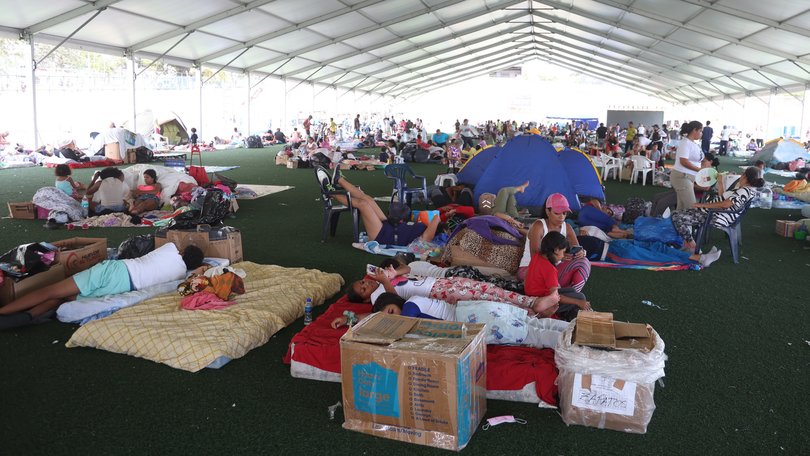 People take refuge in a shelter.