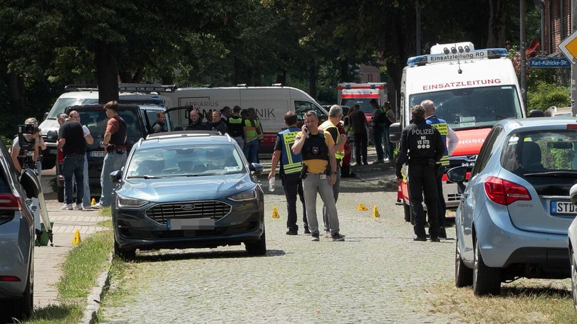Police and rescuers at the scene where several people were killed in a shooting in Stade, northern Germany.