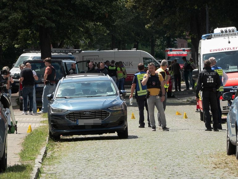Police and rescuers at the scene where several people were killed in a shooting in Stade, northern Germany.