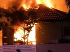A man has died and two are fighting for life after a house fire at Hope Island.