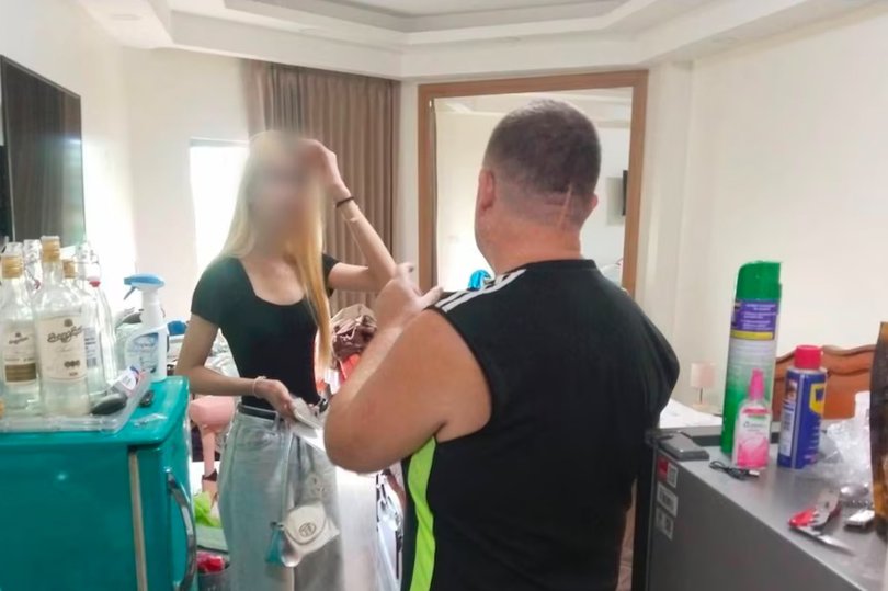 A friend of Tunchanok Donhomla visits the room in Thailand where Australian man Simon Carman allegedly murdered the Thai teenager.