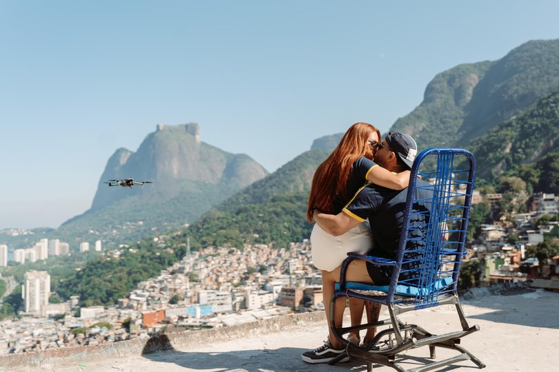 In one of the latest tourist trends, visitors gather at Rocinha’s Porta do Céu, or “Gateway to Heaven,” to have a drone capture the scene. 