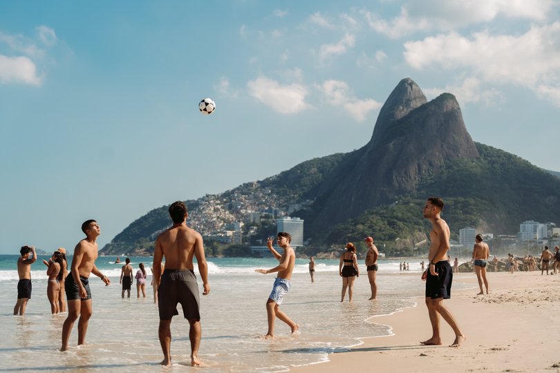 People play footvolley on Rio's Leblon Beach, a popular tourist spot. 