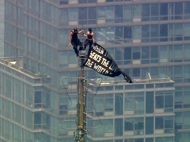 Russian daredevils unfurled a massive banner on top of the Empire State Building. (AP PHOTO)