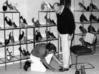 Ray Ashby, manager of Betts and Betts men’s department fitting a customer’s new shoes in 1983.