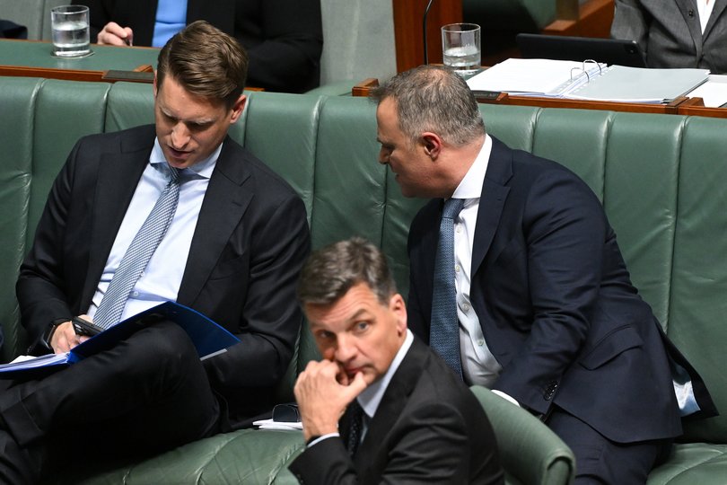 Shadow industry Minister Andrew Hastie speaks to shadow Treasurer Tim Wilson as Australian Opposition Leader Angus Taylor looks on during Question Time.