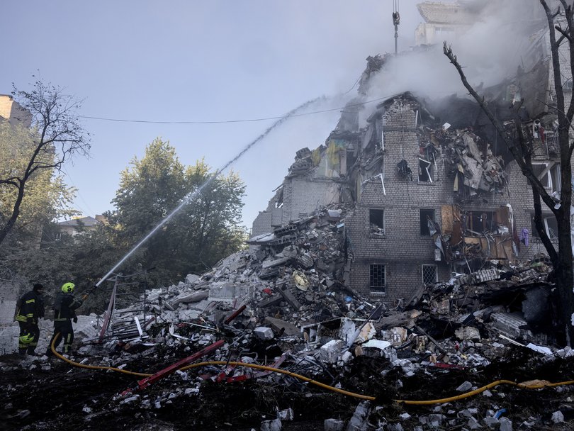 Firefighters at a building that collapsed after the attack.
