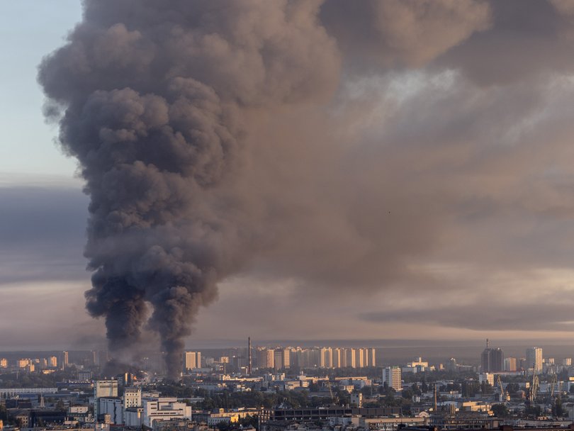 Smoke billows from two major fires burn after a drone and missile attack by Russian forces on Kyiv.