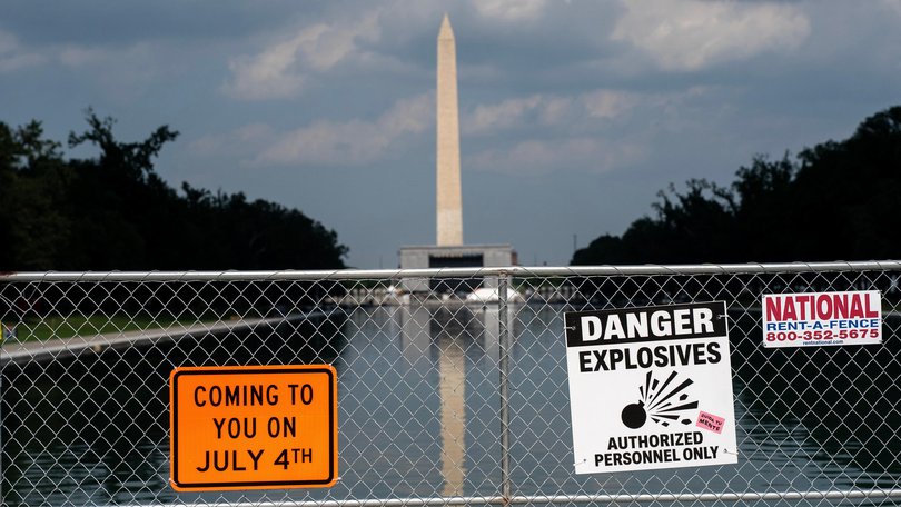 Signage and security fencing warns of explosives along the Lincoln Memorial Reflecting Pool ahead of July 4th events.
