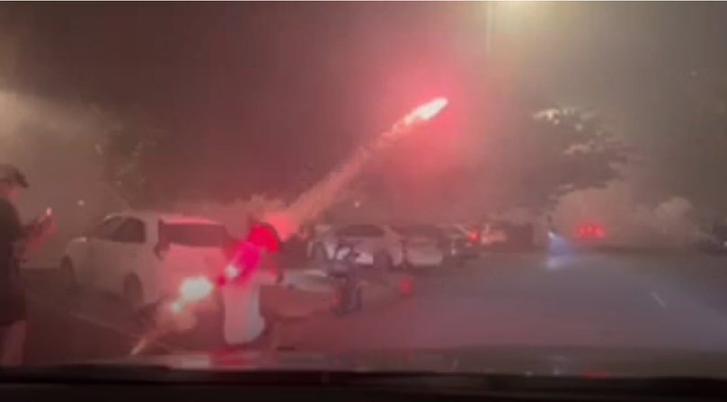 A young man was spotted making a makeshift 'bogan rocket launcher' by launching a firework from a traffic cone at the Darwin Esplanade on Territory Day.