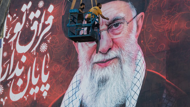 A poster showing the late Ayatollah Ali Khamenei is installed ahead of his funeral ceremonies on July 3, 2026 in Tehran, Iran.