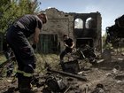 Ukrainian firefighters work at the scene of a Russian drone strike on a military vehicle in the Donetsk region of eastern Ukraine, May 22, 2026. 