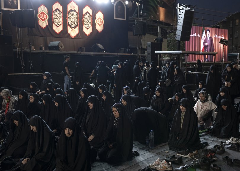 Mourners of Ayatollah Ali Khamenei pray together at Enghelab Square in Tehran, on Friday, July 3, 2026.