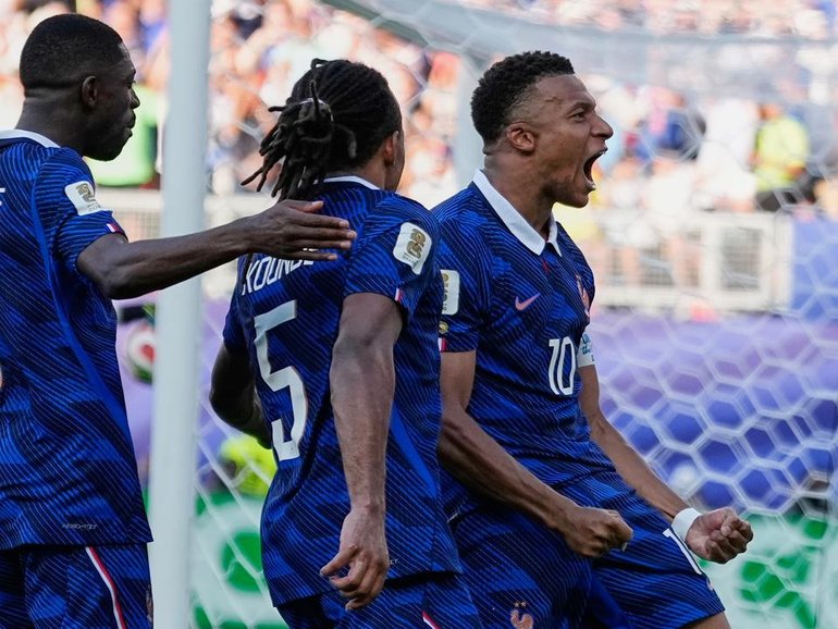 France superstar Kylian Mbappe (r) reacts after scoring from the penalty spot against Paraguay. (AP PHOTO)