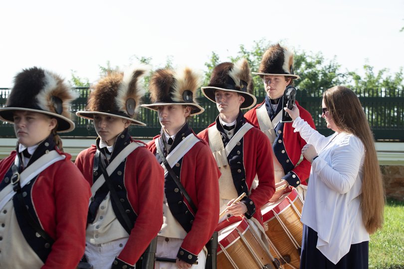 The Lewis and Clark Fife and Drum Corps is cooled down with the help of a small fan held by Director Janelle Stone-Heffner, right, during a naturalisation ceremony at Monticello in Charlottesville, Va., July 4. 2026.
