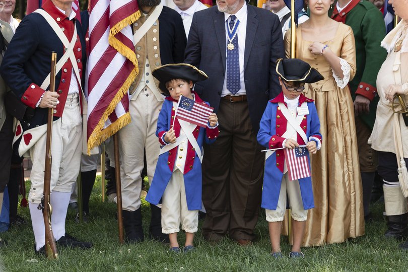 Caleb, left, and Joshua Fendrick, who are visiting from Florida, gather for a group photo after an Independence Day parade was cancelled due to extreme heat, in Philadelphia on Friday, July 3, 2026. (Rachel Wisniewski/The New York Times)