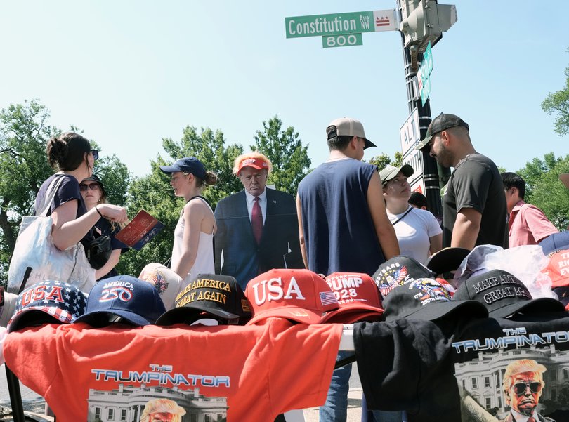 People walk by vendors outside the National Archives as they celebrate the 250th anniversary of the United States in Washington, July 4, 2026. 