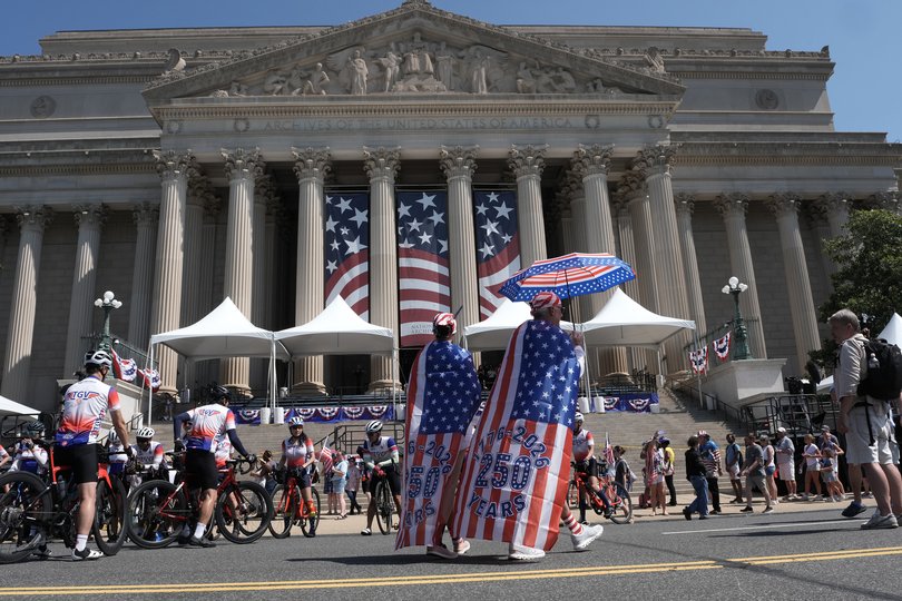 People stop outside the National Archives as they celebrate the 250th anniversary of the United States in Washington, July 4, 2026. 