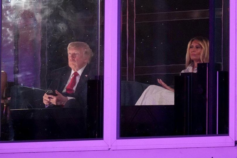 President Donald Trump, left, watches a fireworks show with first lady Melania Trump during Salute to America, an Independence Day event honoring the nation's 250th anniversary, Sunday, July 5, 2026, on the National Mall in Washington. (AP Photo/Mark Schiefelbein)