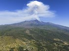 A cloud rose 1.5km above Mount Etna's peak, with the wind expected to carry ash southwards.