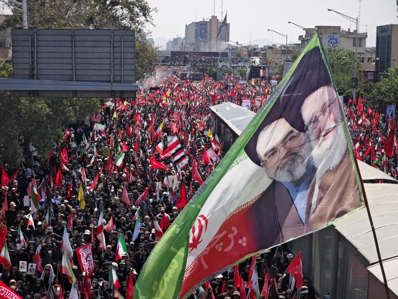 Mourners gather with flags to pay final respects to Iran's slain Supreme Leader Ayatollah Ali Khamenei during the third day of his funeral ceremonies.
