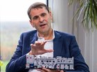 Christophe Fouquet, chief executive officer of ASML Holding NV, holds a model of a semiconductor lithography machine.