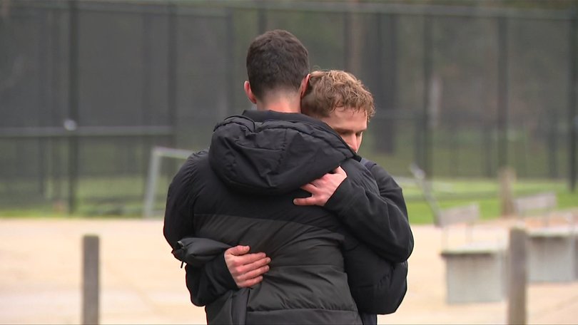 Matthew Fitzgerald hugs Epping Football Club president Luke De Vincentis.