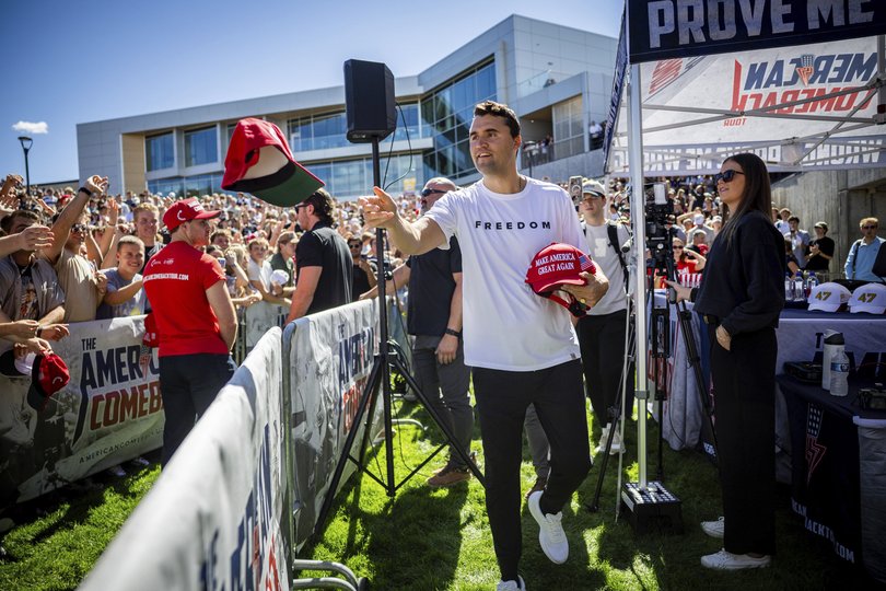 Charlie Kirk hands out hats before speaking at Utah Valley University just before his death.