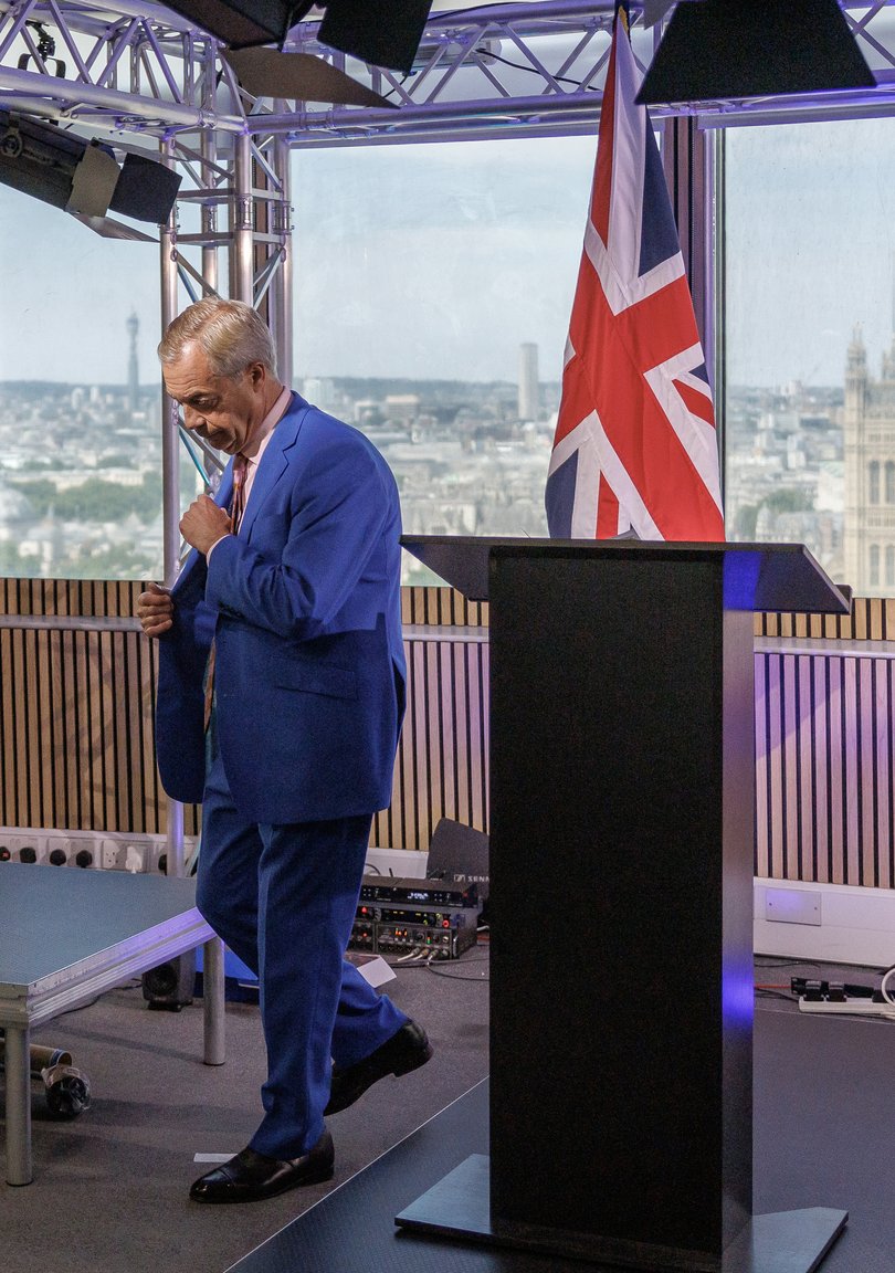 Reform UK Leader Nigel Farage leaves the podium after he announces his resignation.