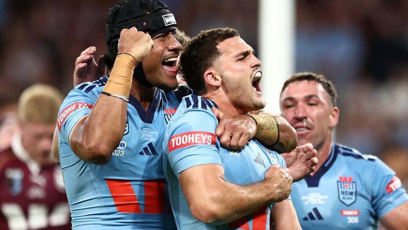 Nathan Cleary of the Blues celebrates with teammates after scoring his team's first try during game three of the Men's State of Origin series.