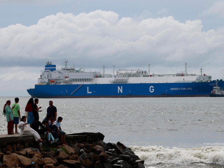 Pre-Monsoon clouds gather above an LNG tanker in India.
